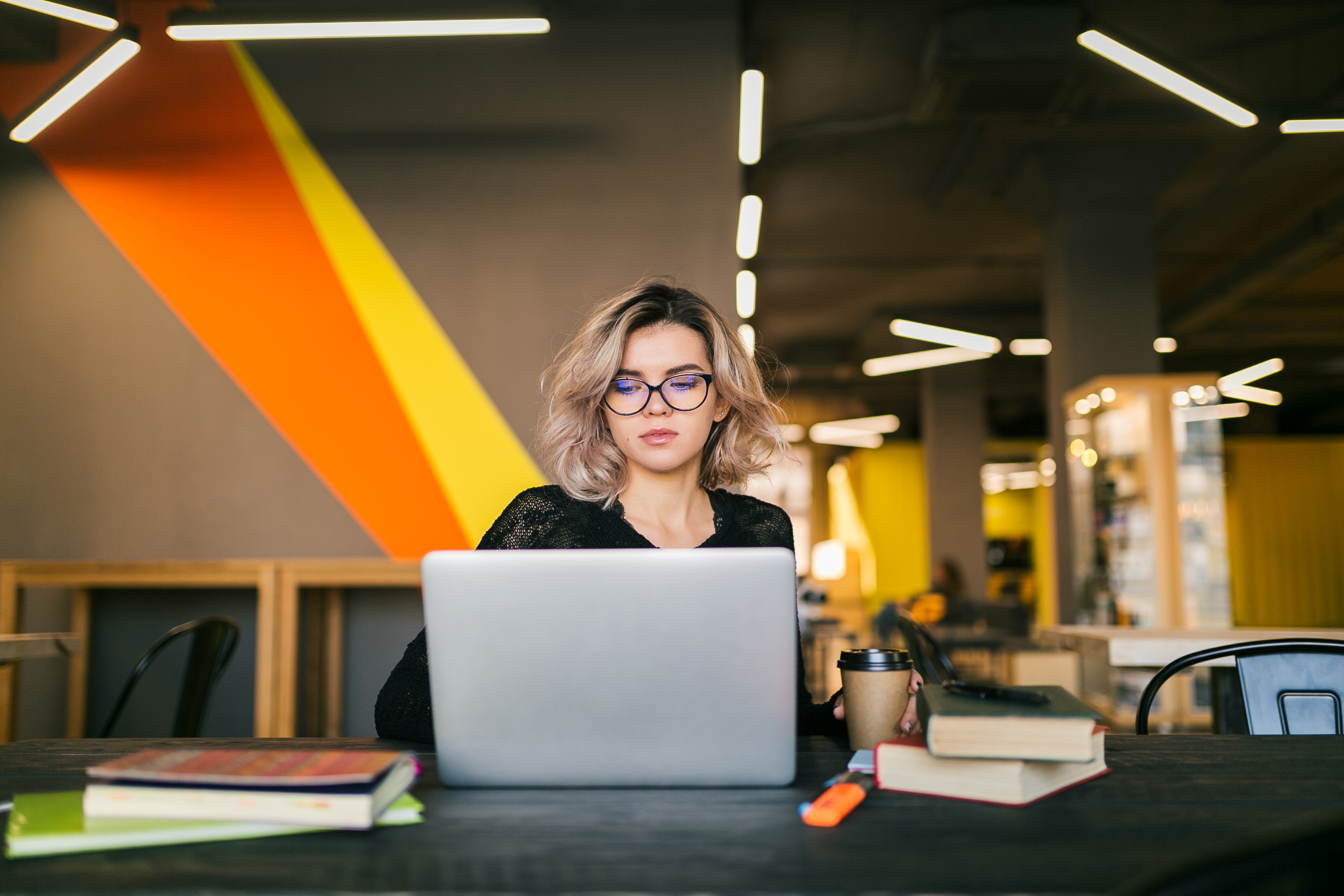 young woman working on laptop in co working office LKGGBJC